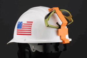 A hard hat with safety goggles attached, showcasing a goggle clip for convenient eye protection on construction sites.