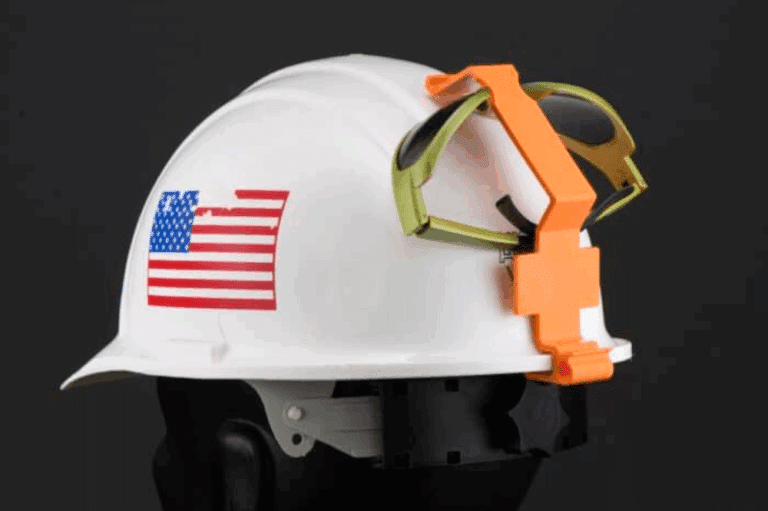 A hard hat with safety goggles attached, showcasing a goggle clip for convenient eye protection on construction sites.